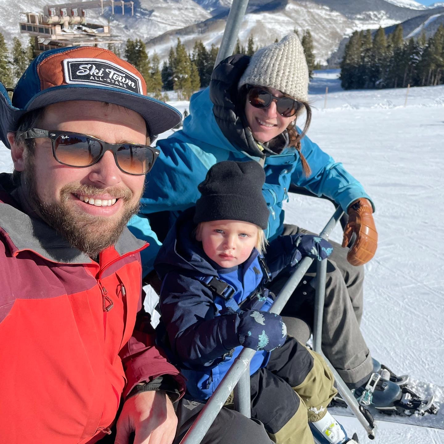 family on a ski lift with a toddler