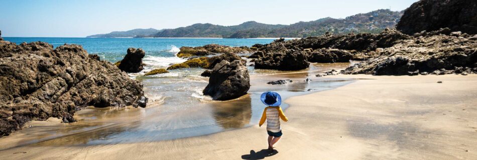 little boy walking on beach in sayulita a perfect family destination